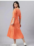 Woman in an orange anarkali dress with ruffled sleeves and calf-length skirt