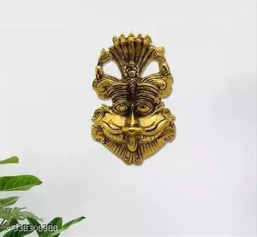 Metal Narsingh face wall hanging, evil eye protector, Feng Shui decorative showpiece from VK COLLECTION. 16 cm x 3.5 cm x 9 cm. Protects from negative energies and brings happiness and prosperity. Made in India