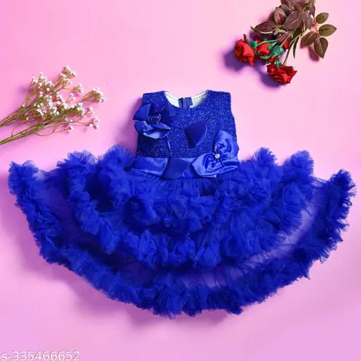 A girl's party dress with a ruffled skirt and flared sleeves