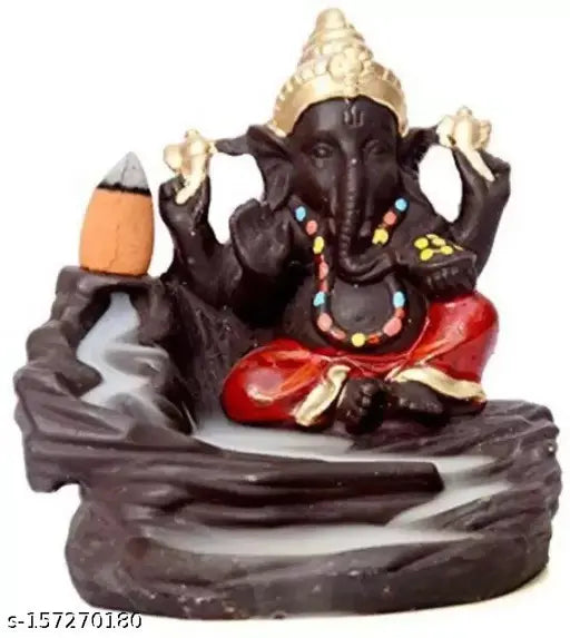 A colorful, decorative figurine of Lord Ganesh with a backdrop of a pond