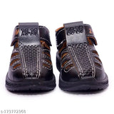 A pair of black closed-toe zoom sandals for kids, with a black strap featuring a textured design