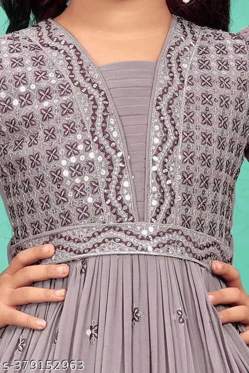 Purple polyester girls ethnic gown, embroidered net with three-quarter sleeves. Inspired by traditional Indian designs, perfect for special occasions