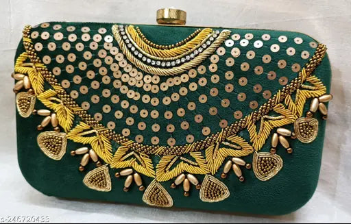 Women's velvet clutch with gold jewelry details, featuring fringe and beading embellishments