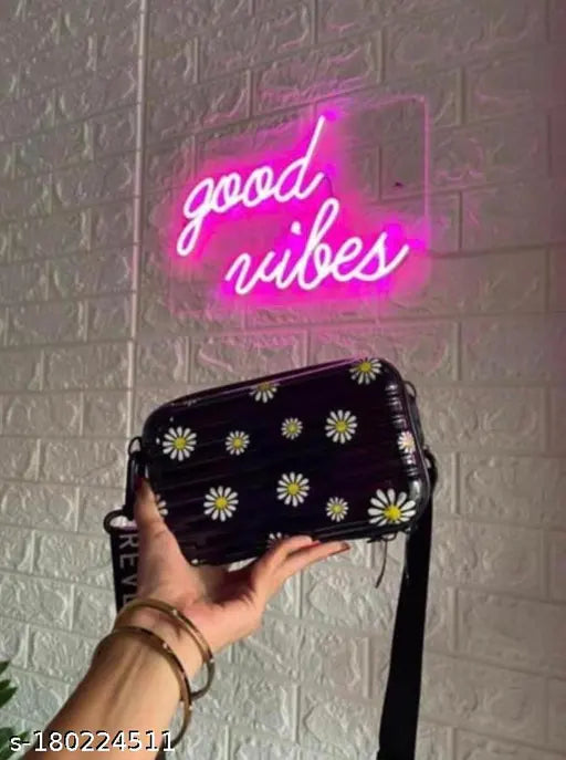 Black small square sling bag with floral print, cute and classy design, attached to a side, suitable for women and girls