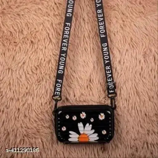Black sling bag for women, featuring a flower design and a black strap