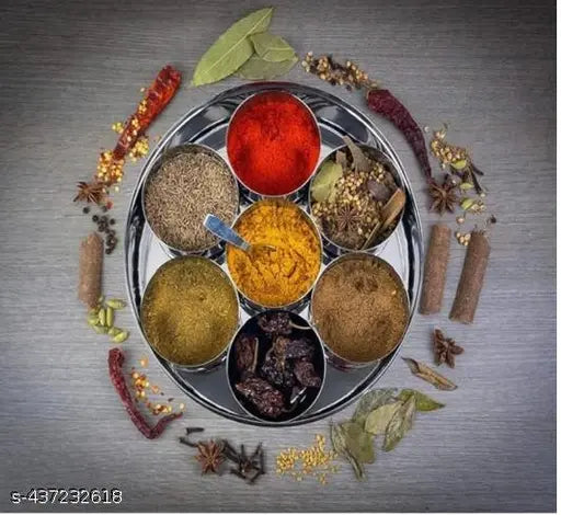 A round stainless steel dabba with various spices in jars, indicating a masala dabba for kitchen use