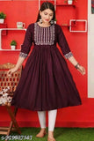 A woman in a long, deep navy blue Anarkali style dress