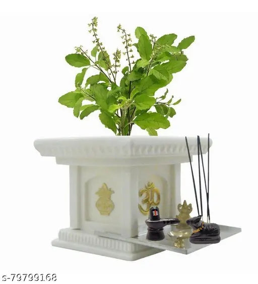 White ceramic shivling idol with basil plant, decorative altar with Om symbol.