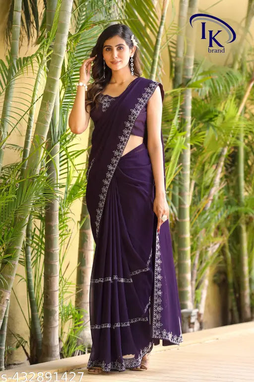 A purple and white patterned saree on a woman