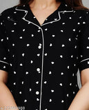 Women's black rayon printed nightsuits with short sleeves and matching pyjama bottoms, featuring intricate design on display