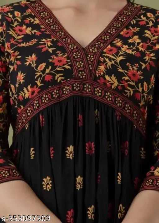 Elegant black Georgette floral print kurti with red and mud color accents, ideal for Diwali and Navratri wear. Pure rayon, handmade, three-quarter sleeves, A-line fit. Comfortable, affordable, and under budget for women. Handloom ethnicwear from India
