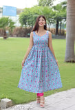 A person is standing, wearing a blue and yellow multicolored sleeveless anarkali dress with pink leggings