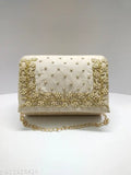 Handmade roll clutch with embroidered detailing and gold trim