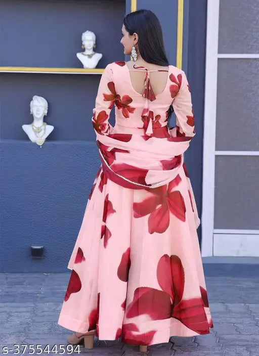 A woman in a pink and white patterned tebbi silk regular fit round neck casual wear gown with a matching dupatta