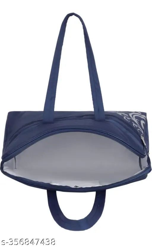 The handbag in the image is a stylish accessory, designed with a combination of navy blue and white colors. It features a sturdy black handle for carrying and a zipper closure, ensuring secure storage of items inside