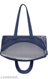 The handbag in the image is a stylish accessory, designed with a combination of navy blue and white colors. It features a sturdy black handle for carrying and a zipper closure, ensuring secure storage of items inside