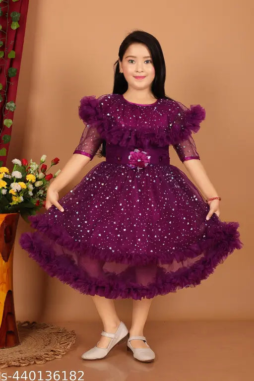 The image shows a young girl wearing a purple dress