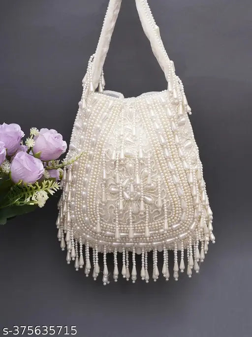Off-white hand embroidered purse with fringe detail