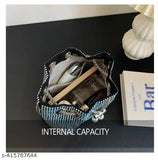 A small women's clutch bag with drawstring closure, rhinestone accents, and a crossbody strap
