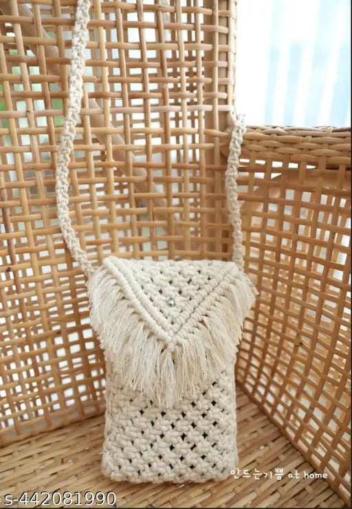 Black woven purse with a brown fringe and side shoulder strap. Small handbag for women, perfect phone bag or cellphone purse. Made of leather or a leather-like material