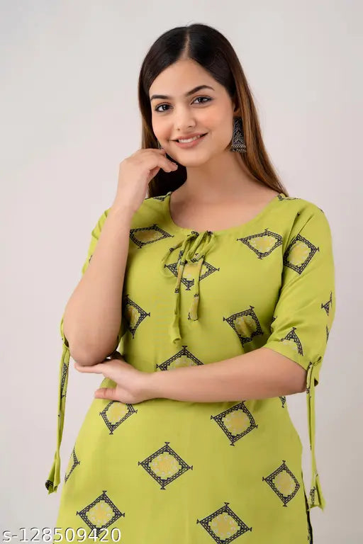 Green Rayon Floral Kurti with Printed Plazo Set, ideal for casual and party wear. Stylish women's kurti with three-quarter sleeves, available in multiple sizes. Indian festival-ready design, perfect for a card party