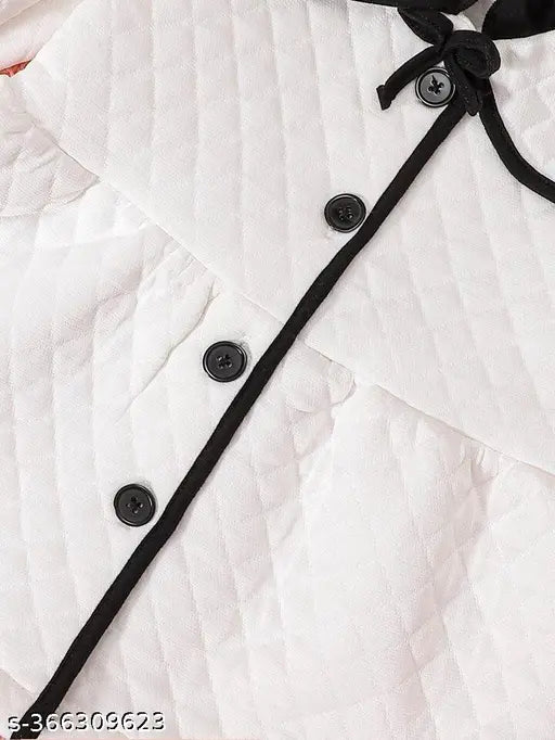 White winter coat with black trim and buttons