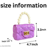 The image shows a small, purple handbag with pearl accents and a chain strap, which can be worn as a shoulder or crossbody bag