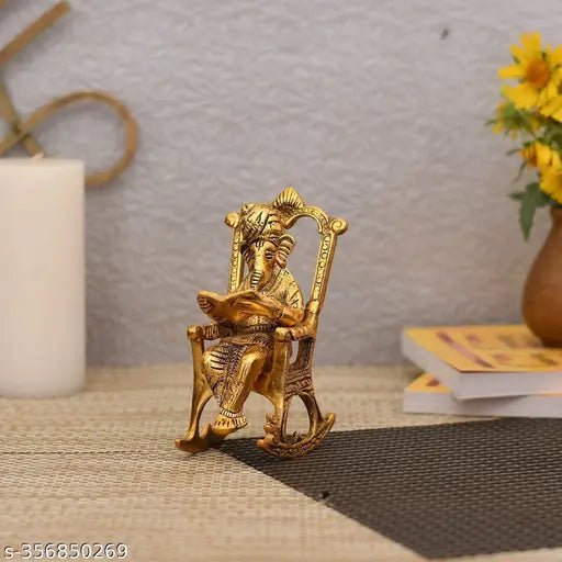 Antique golden brass Ganesha statue reading book, seated Ganesh idol on a chair