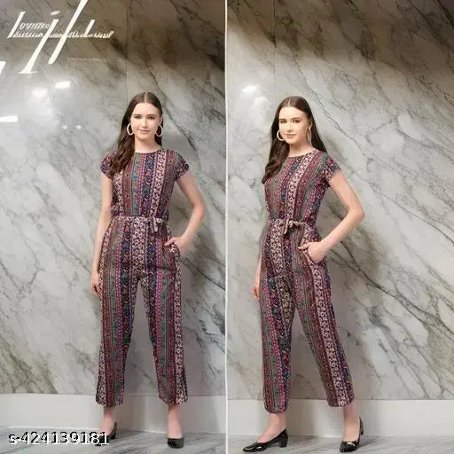 Colorful ethnic Jaipuri print crepe jumpsuit, comfortable and stylish, featuring round neck, short sleeves, and cinched waist with tie belt. Made of soft, breathable crepe fabric with functional side pockets. Available in sizes S, M, L, XL, and Free Size. Care instructions included. Indian-made fashion accessory on display