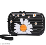 Mini suitcase with side belt, hand strap, and a floral daisy design on a black background. A small travel bag