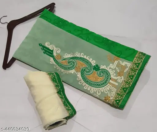A green and gold embroidered half saree with intricate patterns