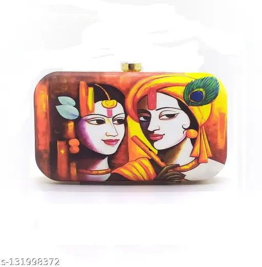 The image shows a decorative clutch bag with a religious print featuring two figures, possibly from Indian culture, set against an orange background. It is adorned with peacock feathers and has one visible pocket on the back