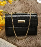 Black leather purse with golden chain strap and visible logo on side