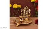 Golden Metal Ganesh Idol with Diya on Leaf - Handcrafted by MISHA, ideal for poojas & festive occasions, unique home decor with lit diya