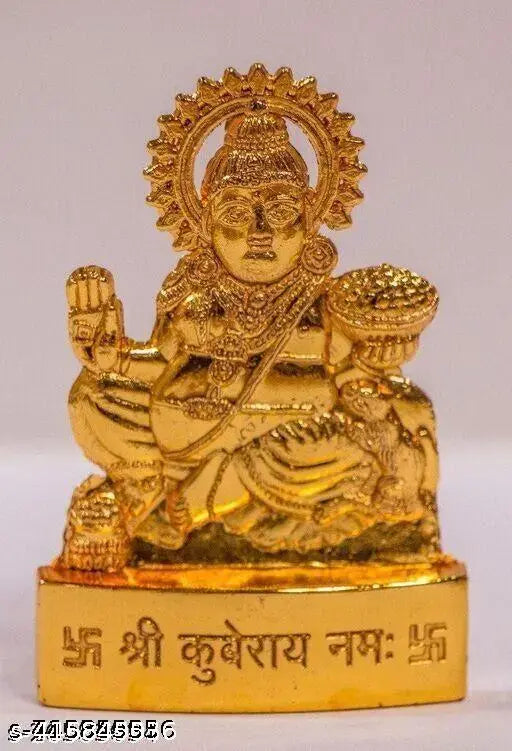 Brass idol of Hindu deity Lord Kuber, ornamented with gold in a sitting position, on a white plinth