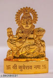 Brass idol of Hindu deity Lord Kuber, ornamented with gold in a sitting position, on a white plinth