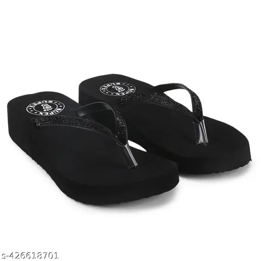Black slippers with white accents, black fabric with flip flap design, pair of fashionable footwear
