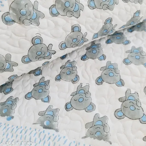 The image shows a colorful quilted bedcover with a block print design, possibly featuring fish motifs. It appears to be made of cotton fabric and is in a quilted style with multiple layers. The quilt has blue, purple, and white hues, suggesting it might have been designed for a child's room