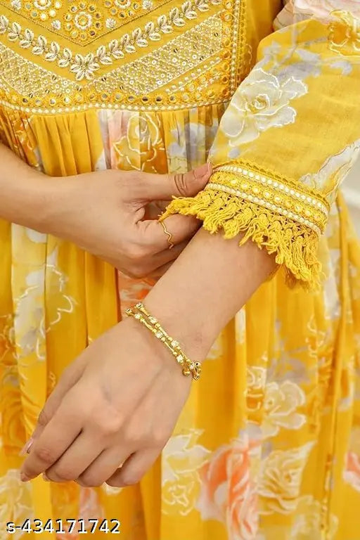 Yellow rayon Anarkali kurti set for festive, featuring printed design and three-quarter sleeves