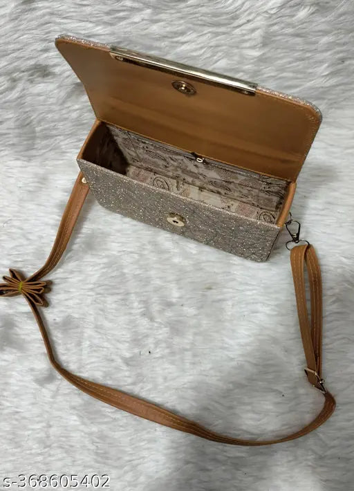 Ladies sling bag with brown trim and a brown strap