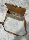 Ladies sling bag with brown trim and a brown strap