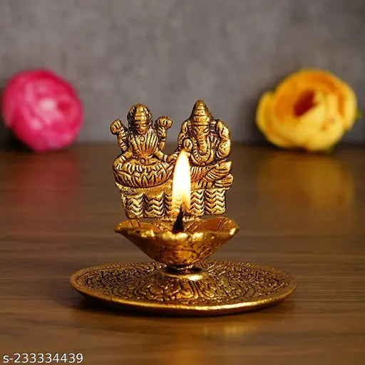 Antique gold plated metal Lakshmi Ganesh hand diya for premium home decorative showpiece, perfect for Diwali or housewarming gifts. (125 characters)