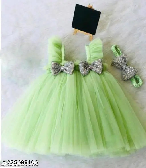 Light green ruffled tulle tutu with bow accents and matching bow headband, suitable for formal events