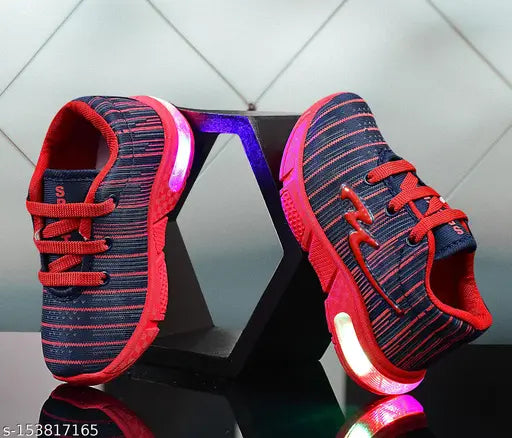 A pair of colorful, sporty sneakers with red soles and orange laces, featuring blue and red stripes. The left shoe is positioned upright on a display stand