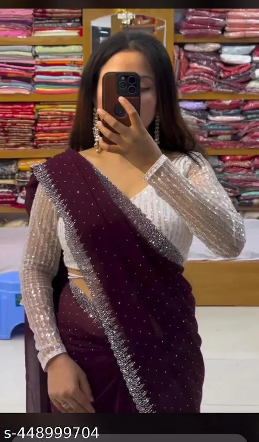 A woman in a red dress taking a selfie with a saree-clad mannequin