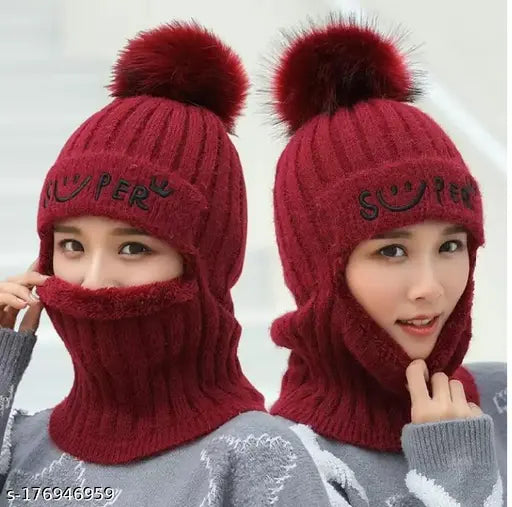 A soft wool beanie with a fuzzy pompom, maroon