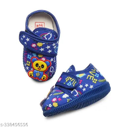 Bright blue sandals with welcro straps and cartoon character design