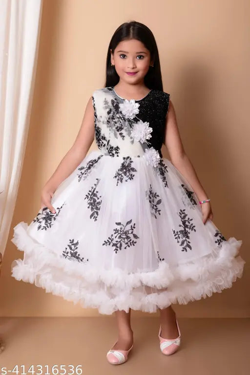 White lace kids' frock with floral patterns and a beaded waistband