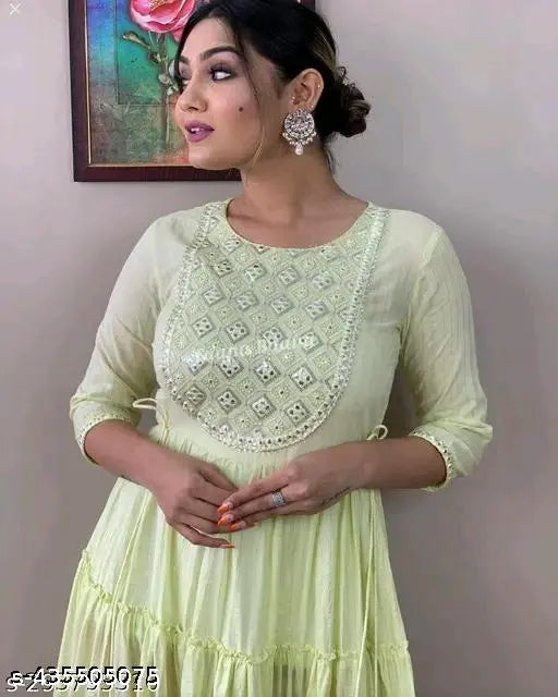 Green dress with embroidered details and elbow-length sleeves