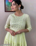 Green dress with embroidered details and elbow-length sleeves